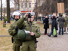 Policemen filming demonstrants.jpg